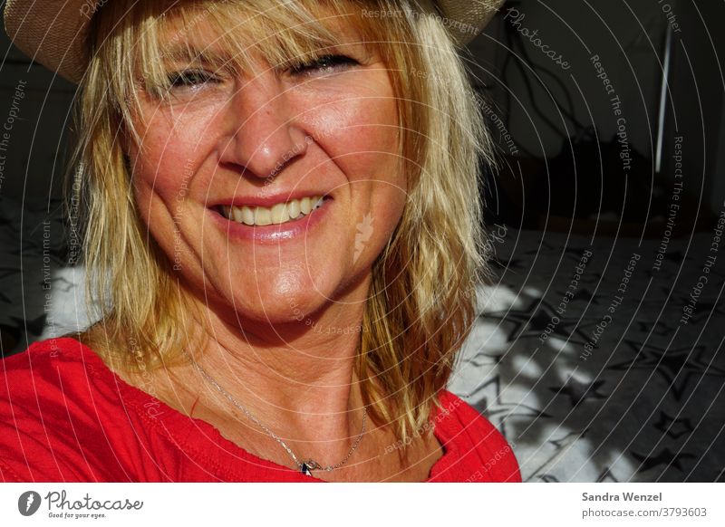 laughing woman with hat in sunlight Sun Woman Hat Blonde Sunlight Laughter Teeth