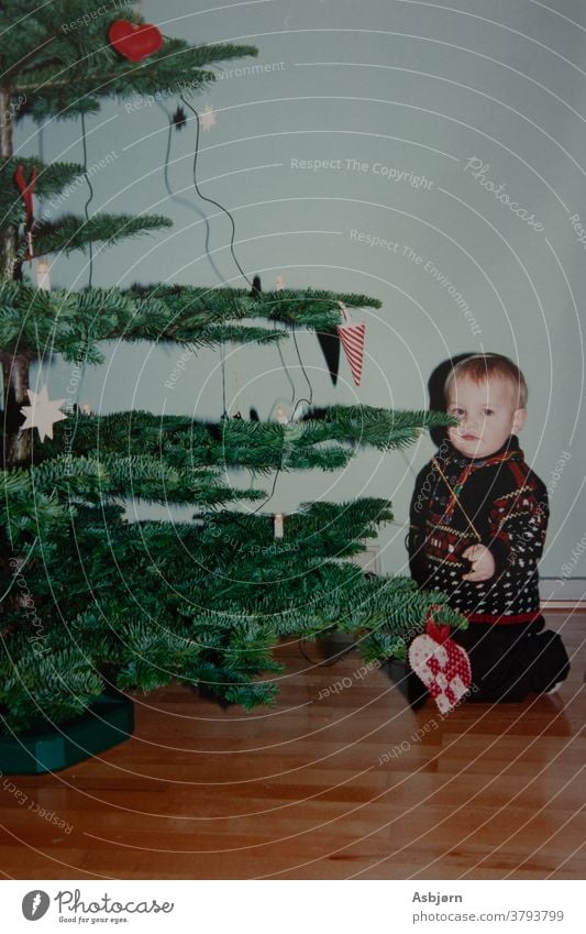 Boy by Christmas tree Film boy kid Christmas & Advent Christmas decoration Christmas tree decorations Colour photo sitting old retro Scan retro style