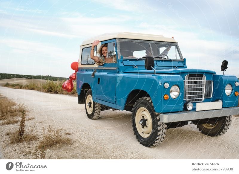 Retro car with air balloons on road vintage shiny parked automobile countryside heart shape vehicle red holiday retro summer nature romantic symbol style