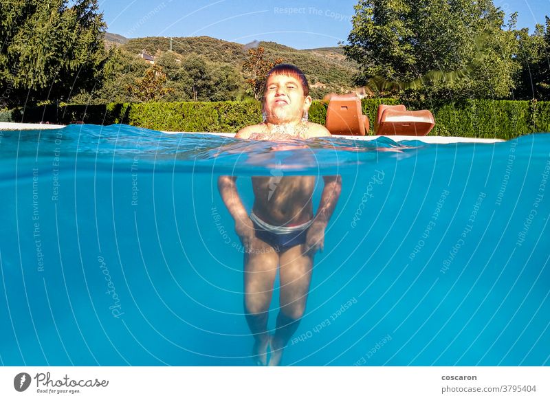 Little boy playing on a swimming pool active activity arms beautiful blue child childhood cute drop emotion enjoy enjoying fun happiness happy head healthy