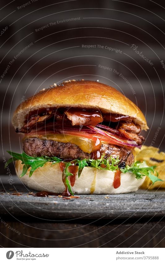 Appetizing hamburger on plate in cafe lunch cutlet delicious sauce rucola fresh appetizing nutrition food tasty meal serve table cuisine gourmet yummy tradition