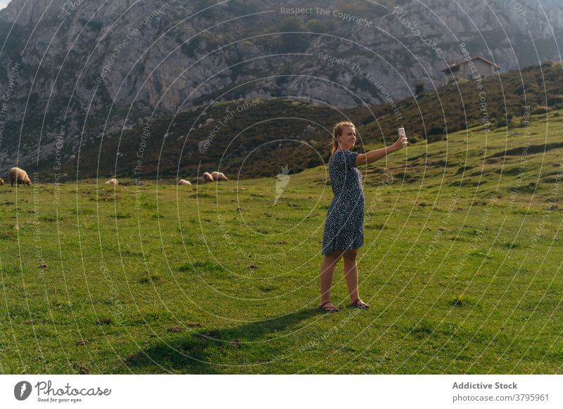 Woman taking selfie with spectacular mountains valley on background woman highland take photo smartphone amazing landscape memory moment environment picturesque