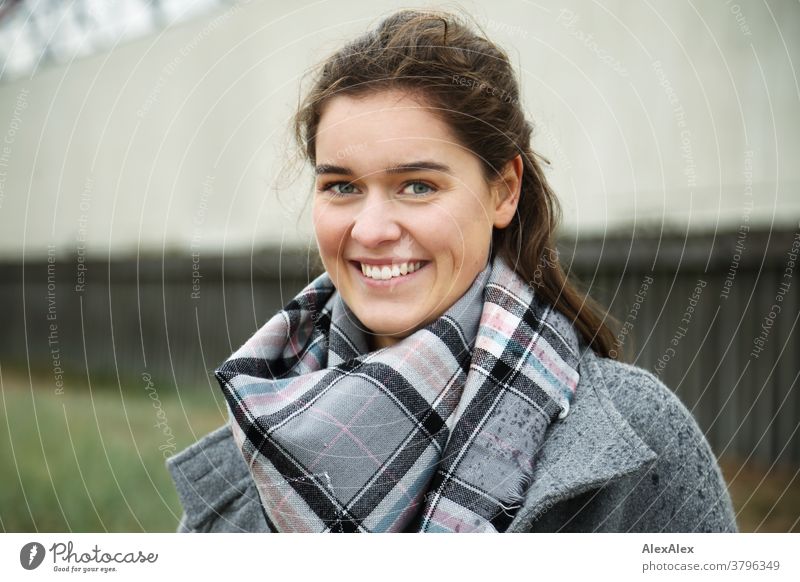 Close portrait of a young woman with dimples standing outside a building Woman Young woman 18-25 years pit Smiling Joy warmly pretty Charming Slim Brunette