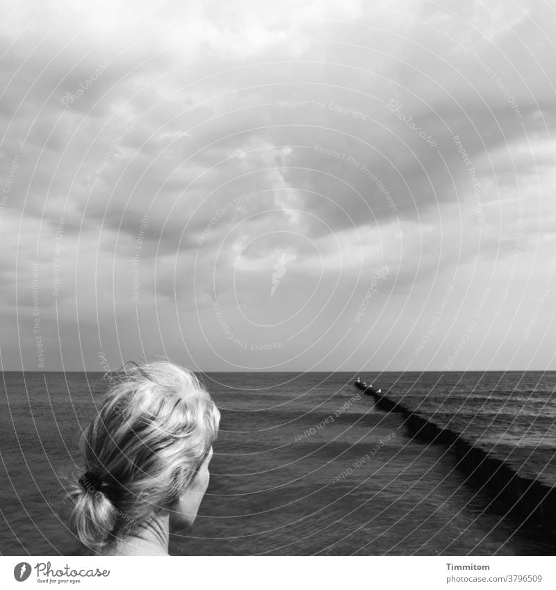 View of groynes and water Woman pretty hair Blonde Head Neck Baltic Sea Water Waves Black & white photo Rest relaxation Vacation & Travel Ocean coast