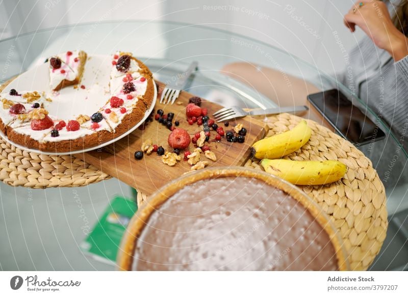 Woman enjoying homemade vegan desserts with fruits and berries healthy food cake pastry berry sweet vegetarian woman kitchen yummy tasty veggie baked banana nut