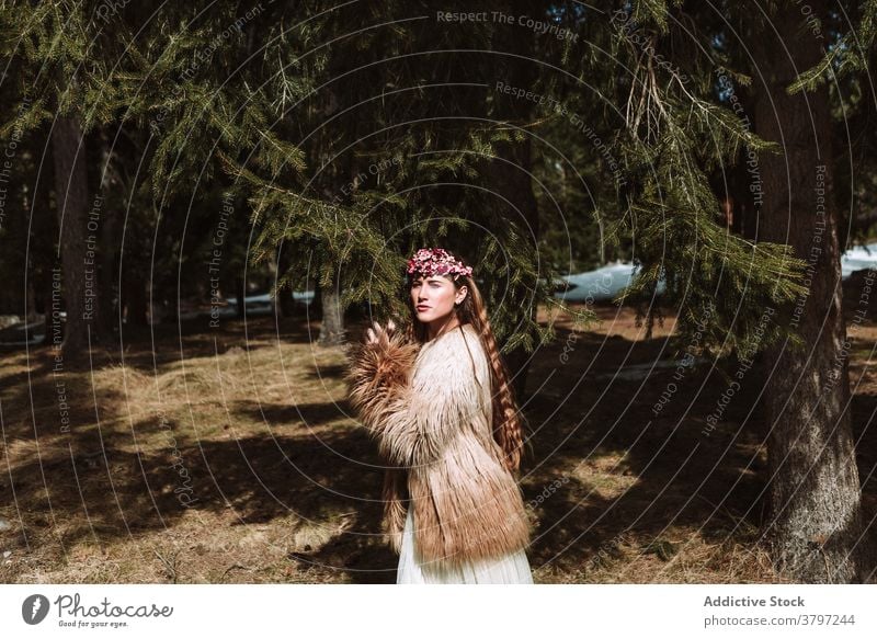 Tender young woman in flower wreath standing in forest romantic nature portrait tender charming sensual beautiful female floral style natural gentle fresh calm