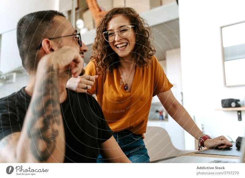 Happy couple having video conversation on laptop at home video call happy together holding hands sofa wave hand cheerful connection relationship boyfriend