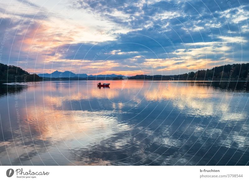 single fishing boat at the lake at dusk Fishing boat Evening Dusk Sunset Twilight Silhouette Landscape Clouds Sky Nature Exterior shot Horizon Fisherman