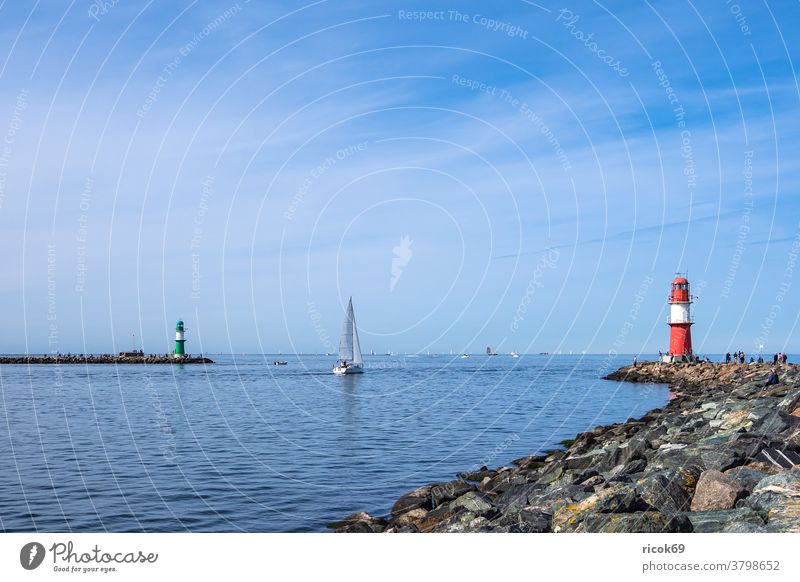 pier with sailing boat at the coast of the Baltic Sea in Warnemünde Warnemuende Mole pier light Rostock Sailboat Baltic coast Ocean Baltic resort