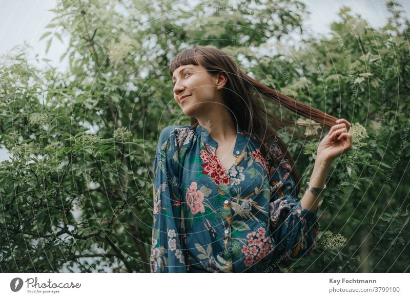 portrait of smiling woman in nature adult attractive balance beautiful brown hair brunette cheerful confidence confident countryside daydreaming face