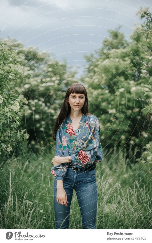 portrait of smiling woman in nature adult attractive balance beautiful brown hair brunette cheerful confidence confident countryside daydreaming face