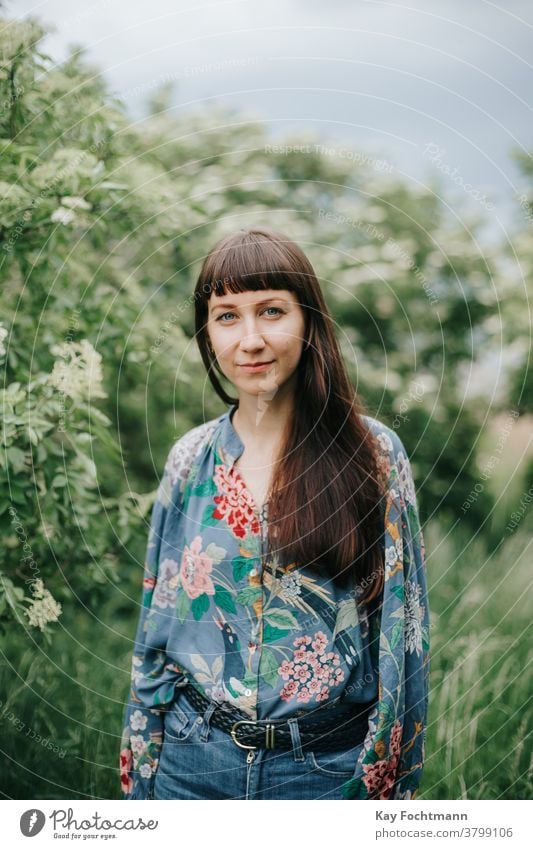 portrait of smiling woman in nature adult attractive balance beautiful brown hair brunette cheerful confidence confident countryside daydreaming face