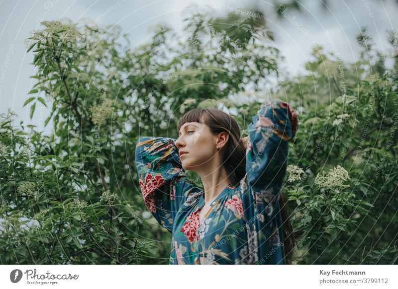 portrait of thoughtful woman fixing her hair adult attractive balance beautiful brown hair brunette cheerful confidence confident countryside daydreaming face