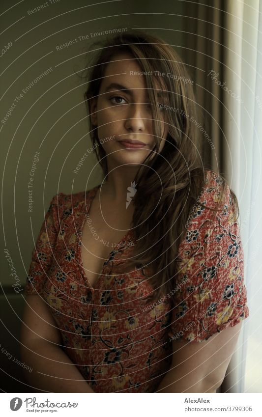 Portrait of a young woman in front of a hotel window portrait Woman pretty Near fit daintily Skin Face look Direct Long-haired Athletic youthful 18 - 30 years