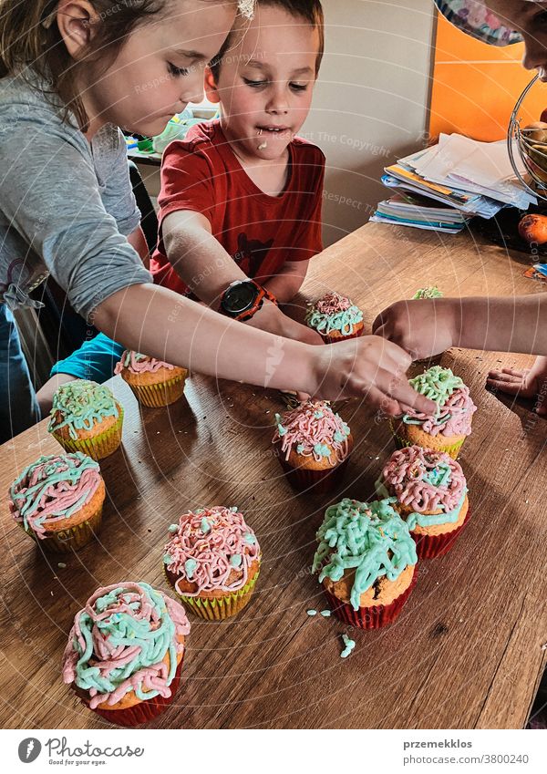 Children baking cupcakes, preparing ingredients, decorating cookies children cooking bake family domestic muffin together childhood happy little kid kitchen