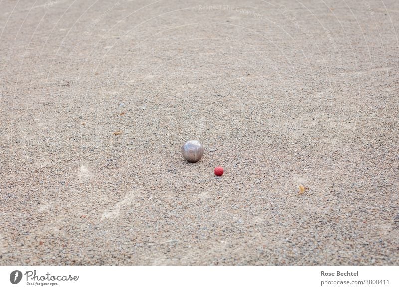 Boule game on gravel court Boules balls Petanque gravel yard Sphere Playing Exterior shot Colour photo Leisure and hobbies Sports Ball sports Copy Space top Red