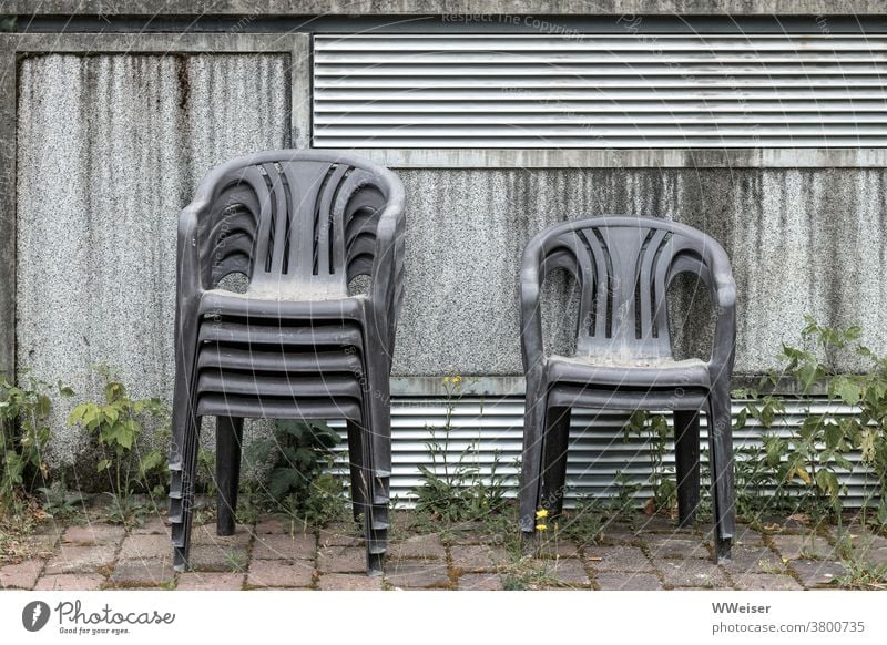 Event cancelled, chairs stacked, anticipation disappointed Garden chairs Plastic chairs pile clean up Wall (building) Garden festival Outdoors Courtyard