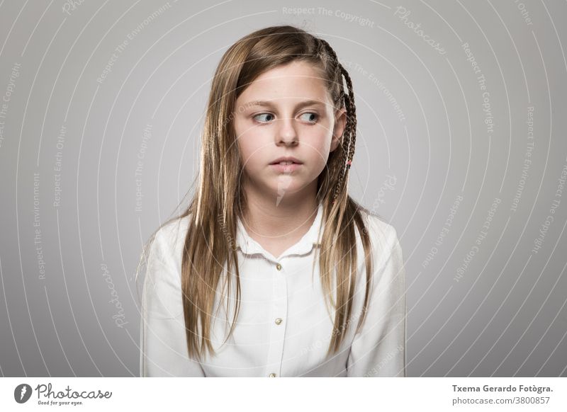 Studio portrait of a cute girl with long blonde hair, who looks questioning in front of a neutral background Girl pretty girl Studio Portrait European Caucasian