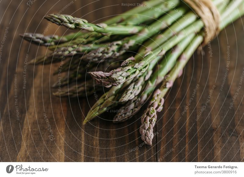 Bunch of raw fresh asparagus on wooden table. Focus on foreground. food green vegetable healthy background diet pepper eating nutrition meal organic fruit