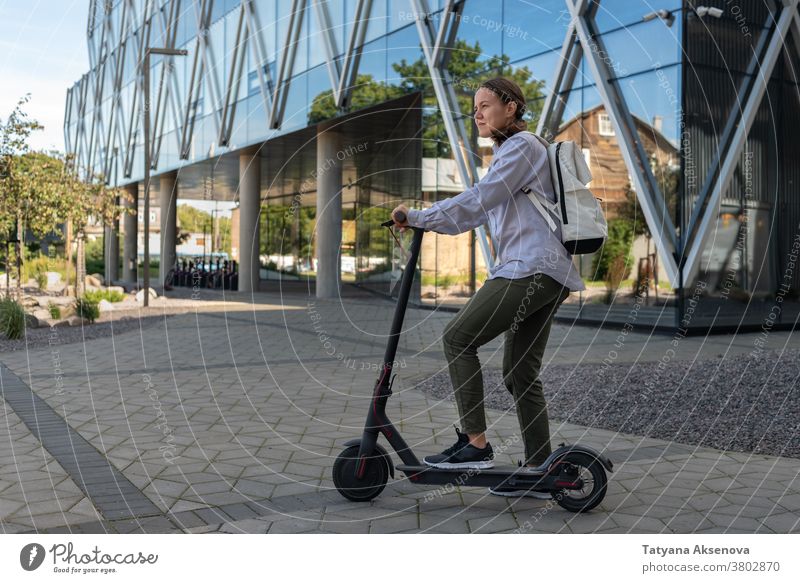 Woman on electric kick scooter riding street city transportation lifestyle modern urban person technology leisure future active electric vehicle woman