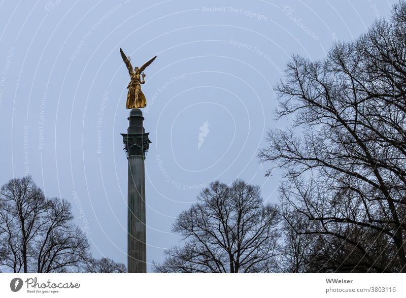 The angel of peace rises golden into the grey November sky Munich Peace Memorial Angel of peace Monument Bavaria War Figure Angel figure Bogenhausen Sky Park