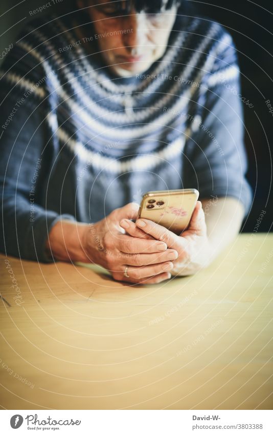 Older woman on smartphone Cellphone Woman older use Reading concentrated Technology hands