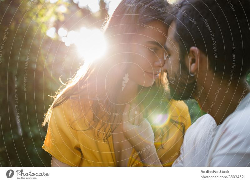 Romantic young ethnic couple spending time together in green park romantic happy love tender spend time garden holiday relationship relax necklace sensitive