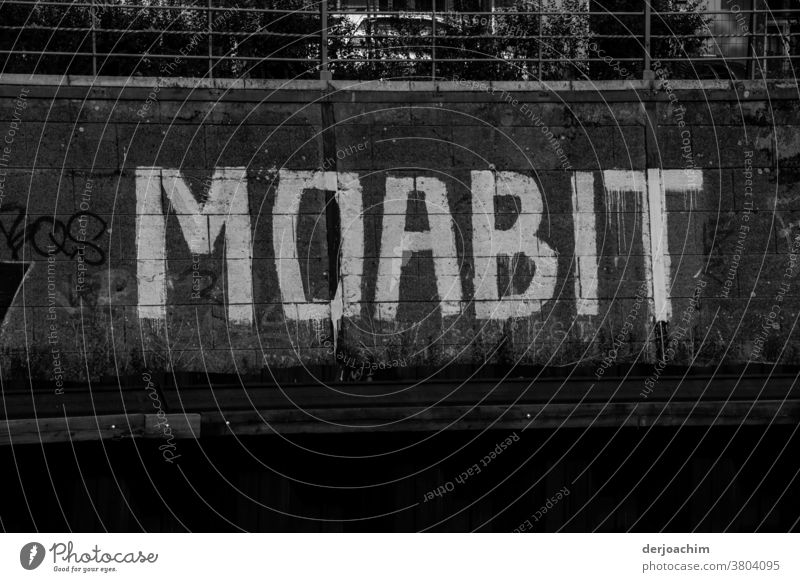 In large white letters on dark background, well visible from the Landwehrkanal. It says : MOABIT . Characters Letters (alphabet) Signs and labeling Signage