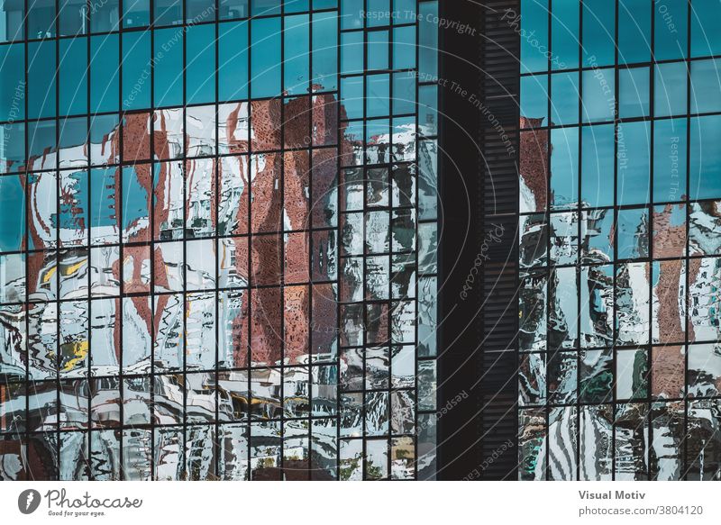 Abstract reflections on the glazed facade of an office building abstract windows urban architecture edifice frontage structure geometric design modern rows blue