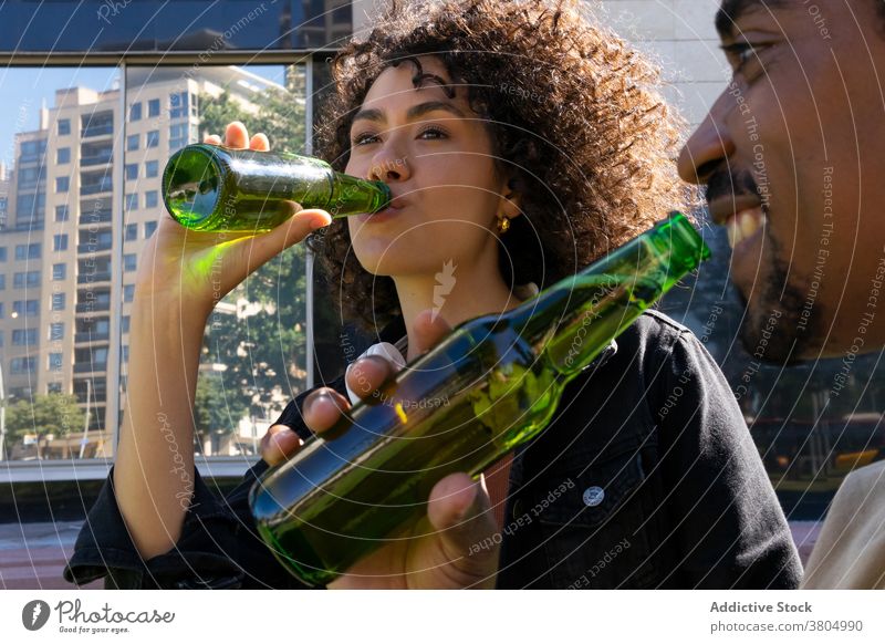 Happy black couple drinking beer on street positive relax cafe spend time together happy enjoy cheerful fun bottle boyfriend girlfriend young african american