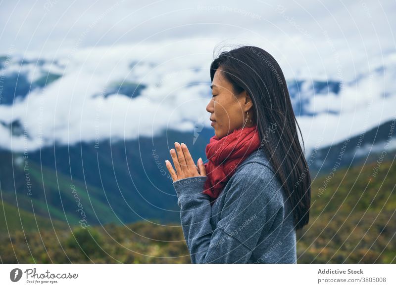 Happy ethnic female hiker in mountain valley woman travel hill meadow highland wanderlust slender cheerful slim skinny nature environment landscape terrain