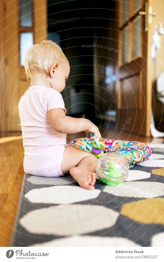 baby girl playing on floor home happy having fun toy grimace love daughter together adorable young child toddler motherhood cute joy bonding relationship enjoy