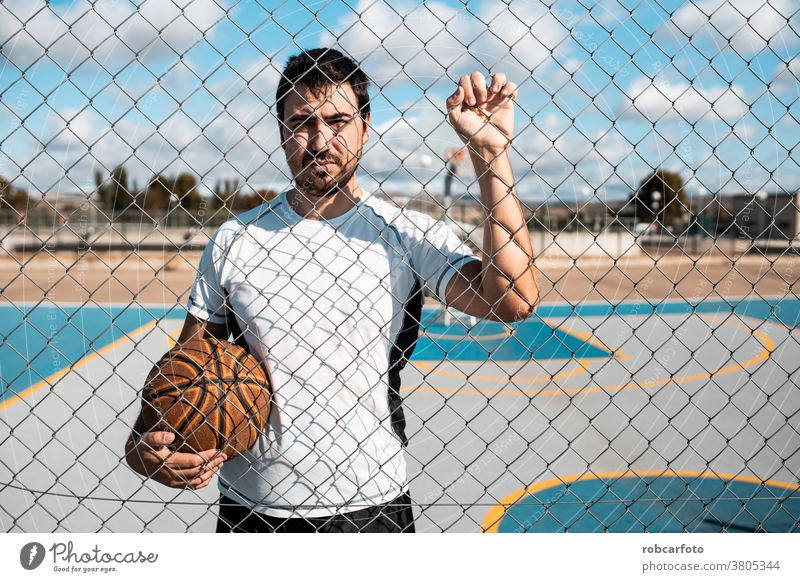 man playing basketball an outdoor court on the street. fun sport urban people cool men shot young game male adult jump hoop score competition leisure african