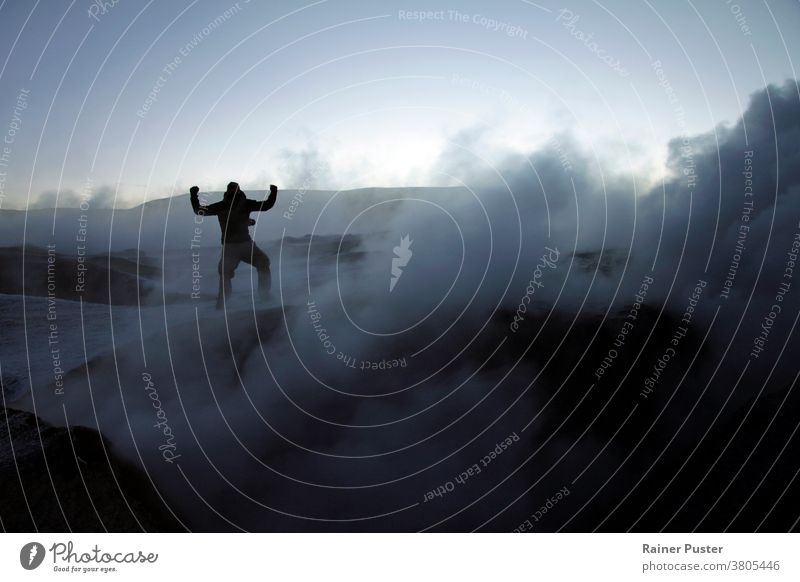 Silhouette of a man in the midst of volcanic smoke on a volcano in Salar de Uyuni, Bolivia, during sunrise achievement achieving goals bolivia cloud concept