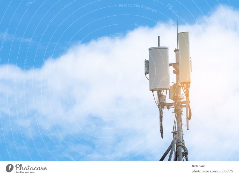 Telecommunication tower with blue sky and white clouds background. Antenna on blue sky. Radio and satellite pole. Communication technology. Telecommunication industry. Mobile or telecom 4g network.