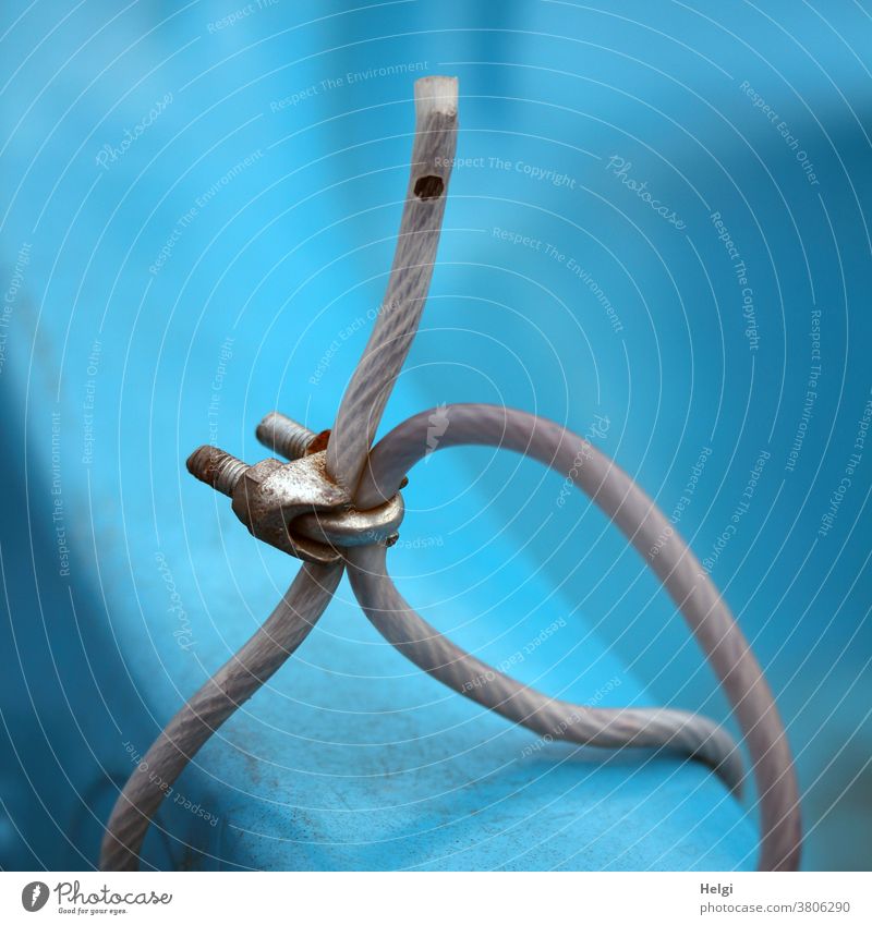 Mooring - detail view of a blue plastic boat that was tied up with a wire rope Wire cable Fastener tethered Screw Plastic Backup anti-theft device Colour photo