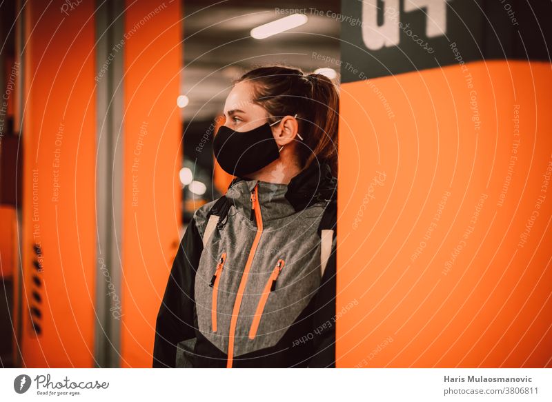 Woman with mask in the garage by the orange wall adult attractive beautiful beauty black casual collection cool coronado bridge coronavirus covid-19 creative