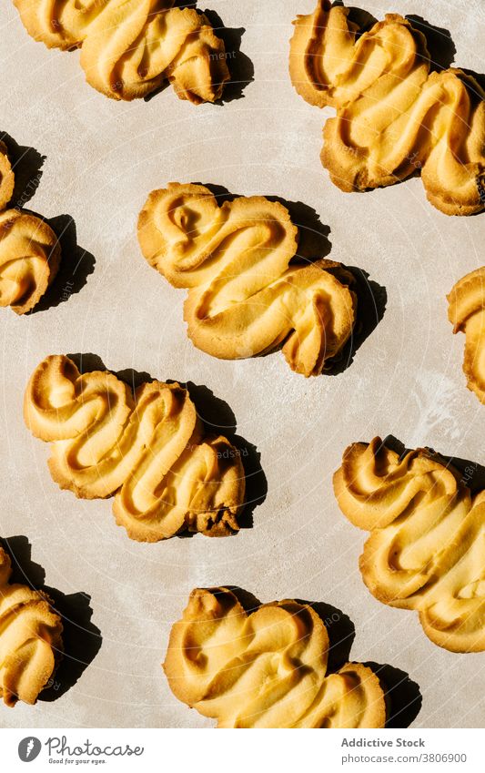 Bright golden baked biscuits with ornament on table treat pastry delicious sweet creative design background decorative colorful yummy natural organic product