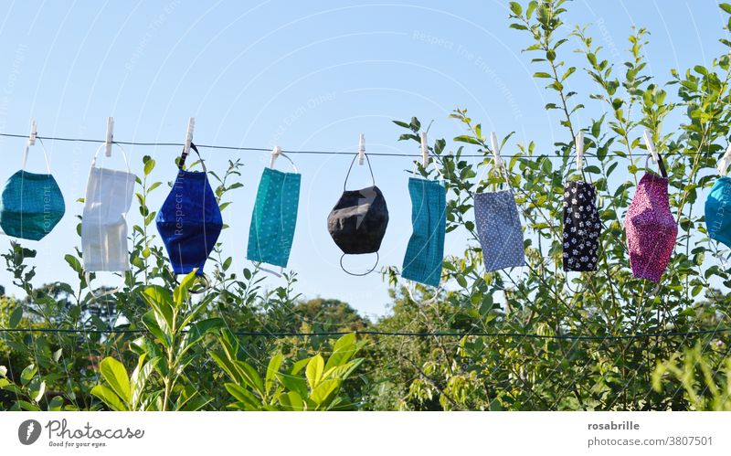 self-sewn masks as face masks in the corona crisis hang on the clothesline to dry after washing | corona thoughts Mask Face mask Respirator mask Protection