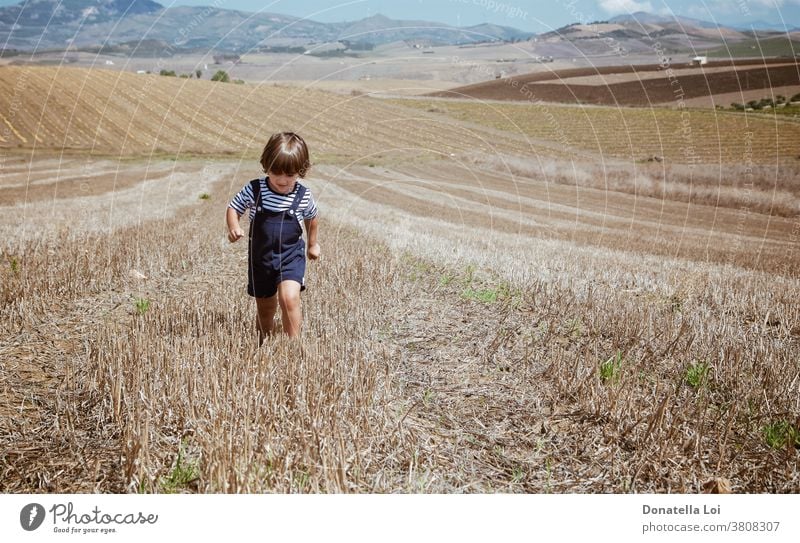 Little boy in rural landscapes 3 years Landscape agricultural landscape alone brushwood casual caucasian child childhood fields green joy little boy male