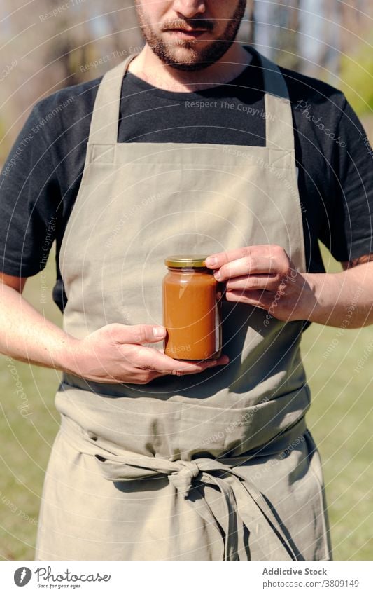 Crop farmer with honey in jar glass man homemade delicious natural nutrition organic male village yummy tasty sweet food rural rustic healthy fresh gourmet guy