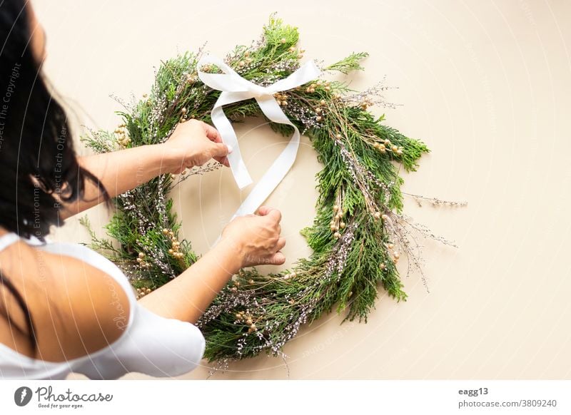 Cute woman decorates advent wreath with her hands Christmas arrangement christmastime circle concept create creative creativity december decorating decorations