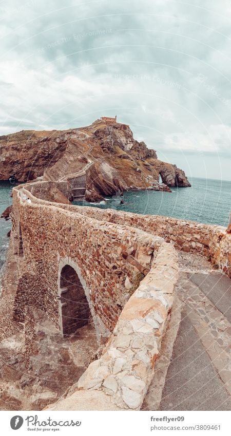 Gaztelugatxe Island in Bilbao, Spain lone rock giant cliff beach nature sharp vizcaya basque country copy space coast travel stone high water view ocean