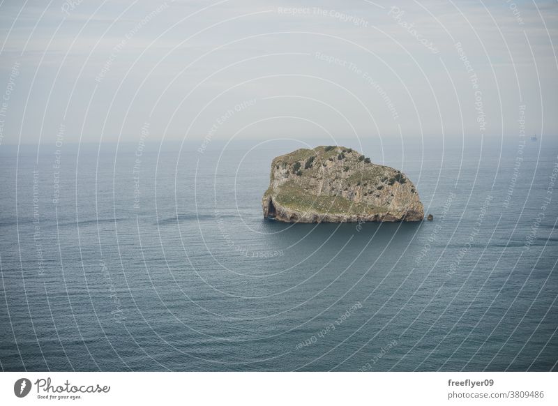 Lone giant rock in the middle of the ocean lone cliff beach nature sharp vizcaya basque country copy space coast travel stone high water view landscape