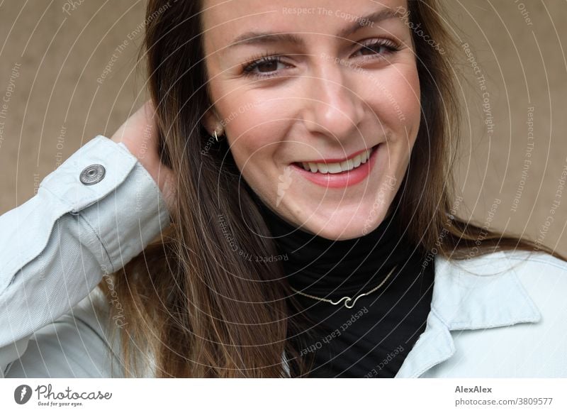 Close portrait of a young, smiling woman with dimples in denim jacket Woman 18 - 30 years pretty fit Slim Jeans jacket smart kind Pleasant Attractive Brunette