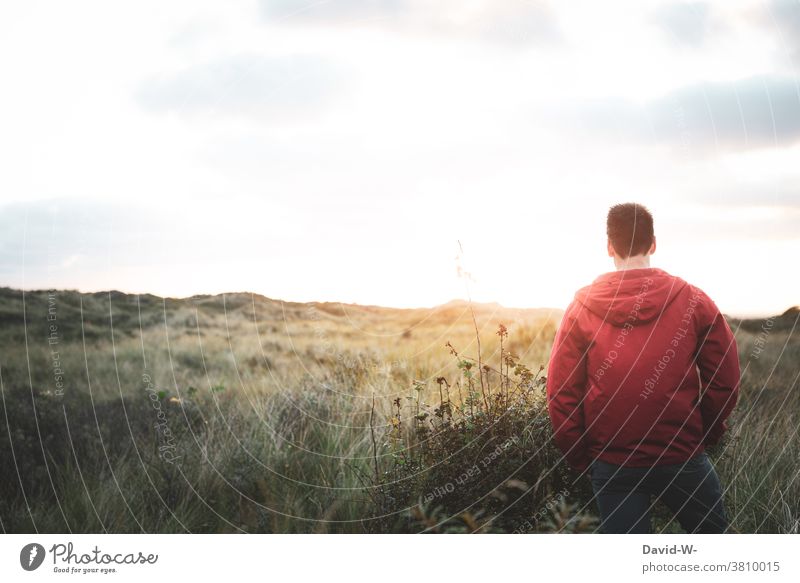 Man enjoys the peace and quiet of nature Landscape tranquillity Nature silent Lonely Sunlight beautifully Sunrise North Sea Rear view