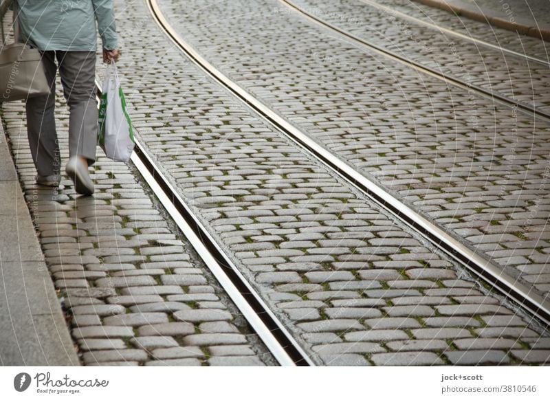 back from shopping, everything does not come in the bag Street Cobblestones rail Traffic infrastructure Legs Shopping bag Going Pedestrian