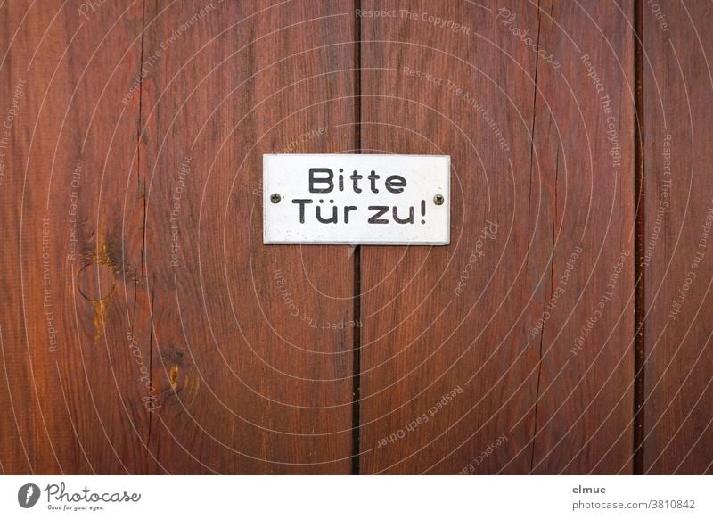 "Please close the door" is written in black on a white sign on a reddish brown wooden door Wooden door Please close the door! invitation Closed Signage