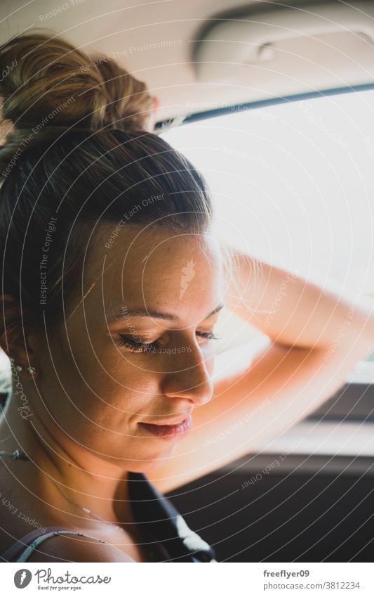 Portrait of a woman on the backseat of a car portrait driving rearview transport trip road trip traffic driver backview mirror face beautiful travel attractive