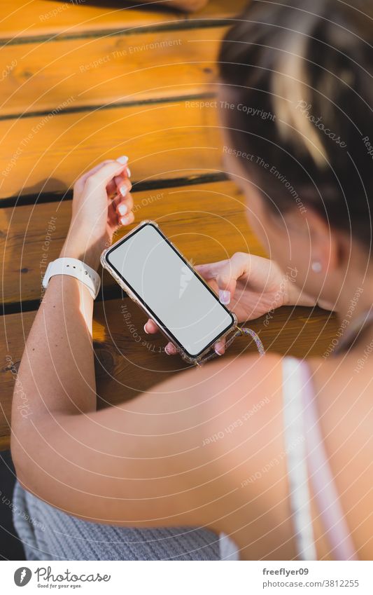 Mockup of a woman using her smartphone on a wood table mockup copy space blank mobile street maps resource media people white hand finger device showing app